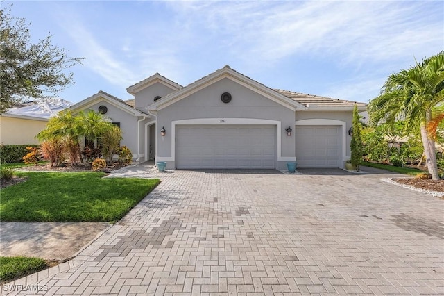 view of front facade with a front yard and a garage