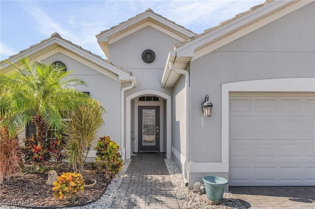 doorway to property with a garage