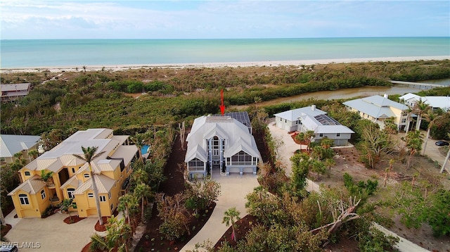 birds eye view of property with a water view and a view of the beach