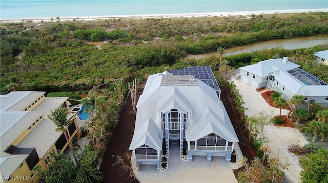 aerial view with a water view and a view of the beach