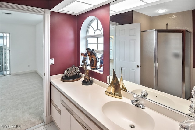 bathroom featuring vanity and a shower with door