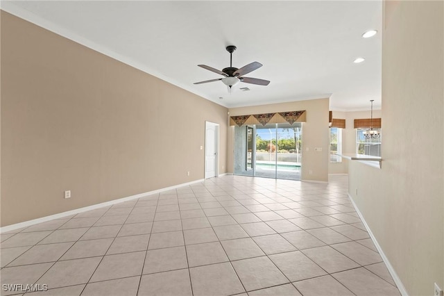 tiled empty room featuring crown molding and ceiling fan with notable chandelier