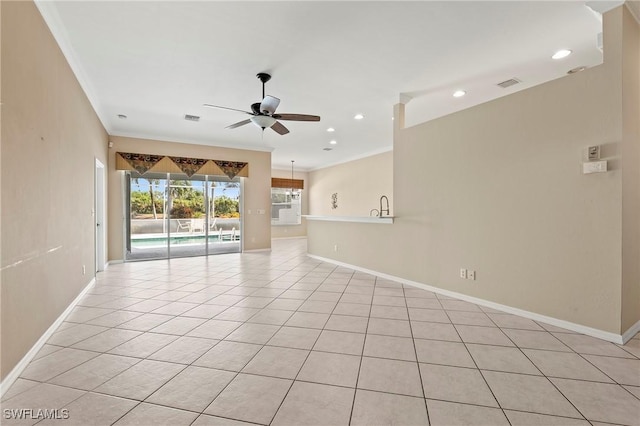 interior space with light tile patterned flooring, ceiling fan, crown molding, and sink