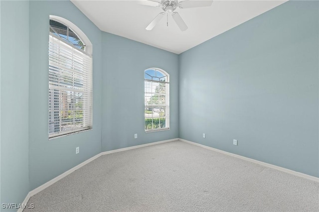 unfurnished room featuring ceiling fan and carpet