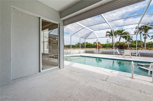 view of pool with a lanai and a patio