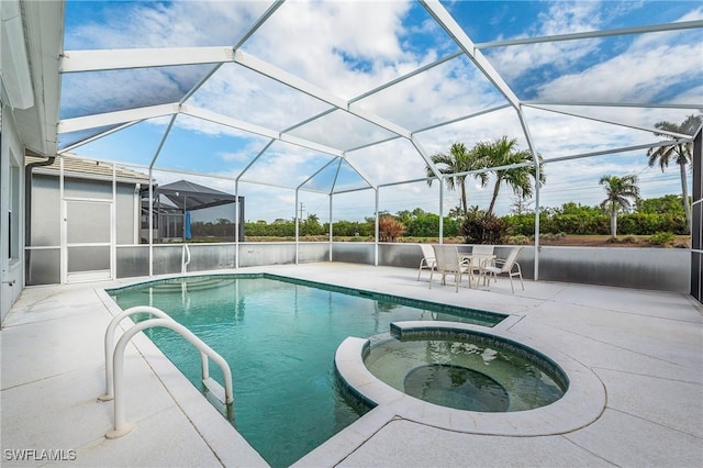 view of swimming pool with a patio, glass enclosure, and an in ground hot tub