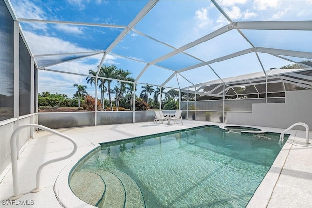 view of pool featuring a patio, glass enclosure, and an in ground hot tub