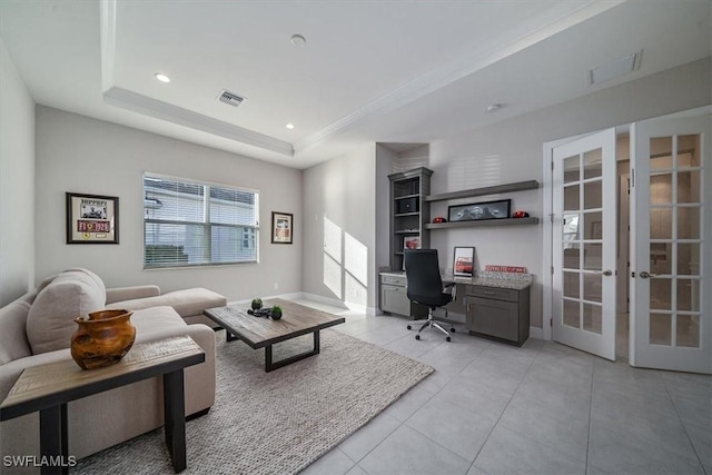 interior space with a raised ceiling and french doors