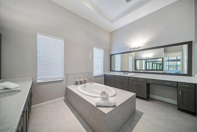 bathroom featuring tile patterned flooring, vanity, tiled bath, and a wealth of natural light