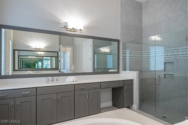 bathroom with a shower with door and vanity