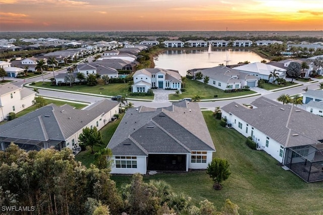 aerial view at dusk with a water view