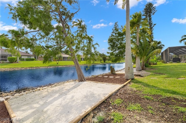 exterior space featuring a lanai and a water view