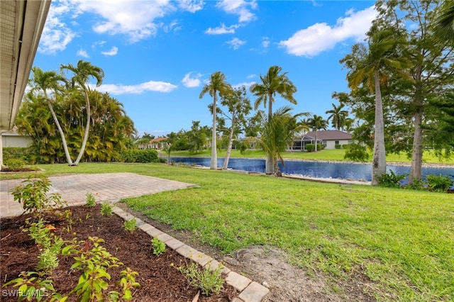 view of yard with a water view and a patio area