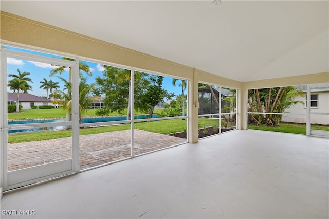 unfurnished sunroom featuring a water view