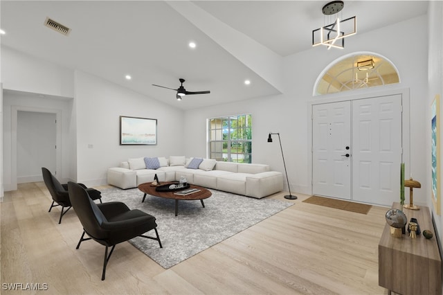 living room featuring high vaulted ceiling, light wood-type flooring, and ceiling fan