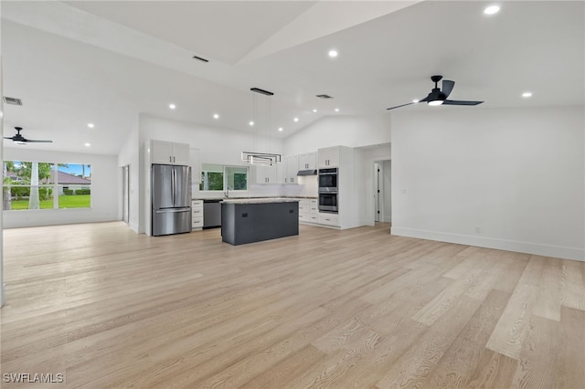 kitchen featuring stainless steel appliances, white cabinetry, ceiling fan, hanging light fixtures, and a kitchen island