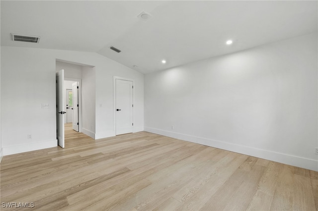 unfurnished bedroom featuring light hardwood / wood-style flooring and vaulted ceiling