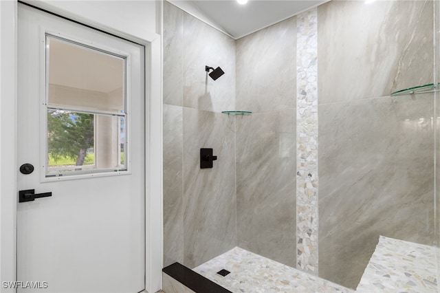 bathroom with tiled shower