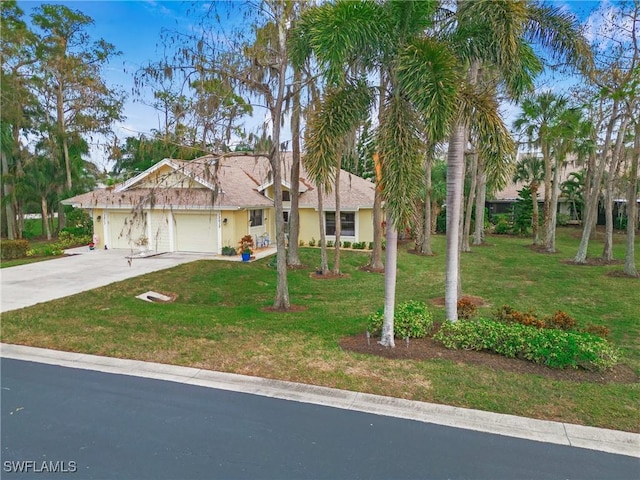 view of front of house with a garage and a front yard