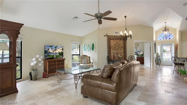 living room featuring vaulted ceiling and ceiling fan with notable chandelier