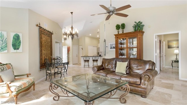 living room with ceiling fan with notable chandelier and high vaulted ceiling