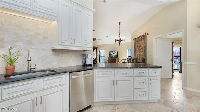 kitchen featuring sink, vaulted ceiling, stainless steel dishwasher, and white cabinets