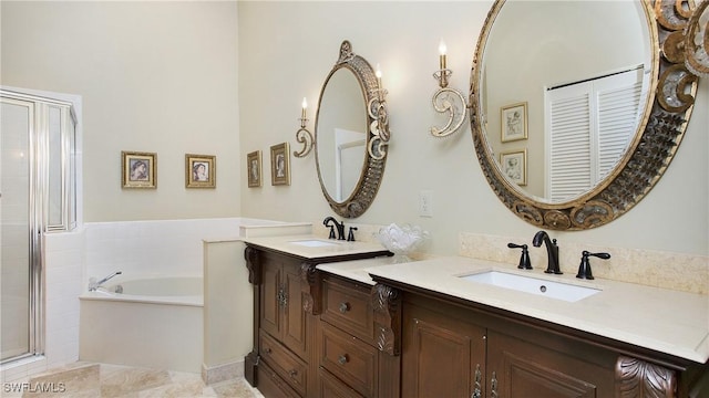 bathroom with vanity and independent shower and bath