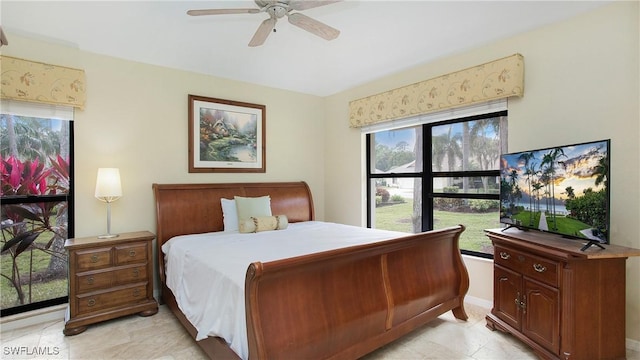 bedroom with multiple windows and ceiling fan