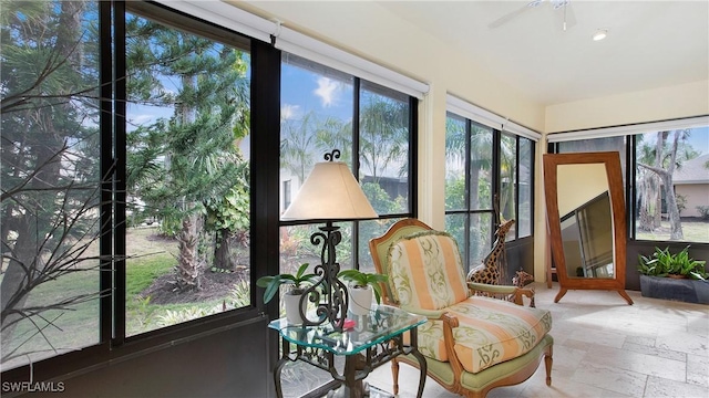 sunroom featuring ceiling fan