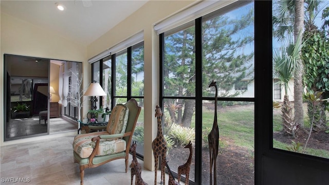 sunroom / solarium featuring lofted ceiling