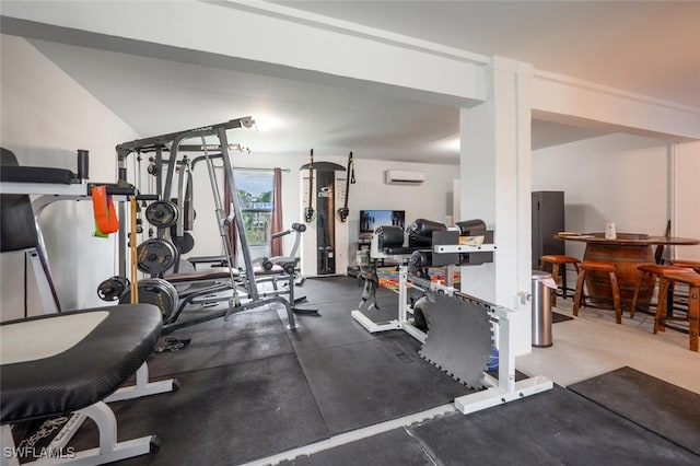 workout area featuring a wall unit AC