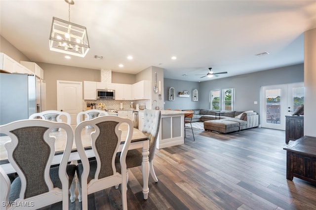 dining room featuring dark wood-type flooring, french doors, and ceiling fan