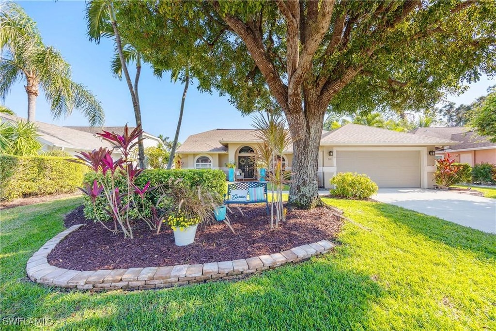 view of front of house with a front yard and a garage