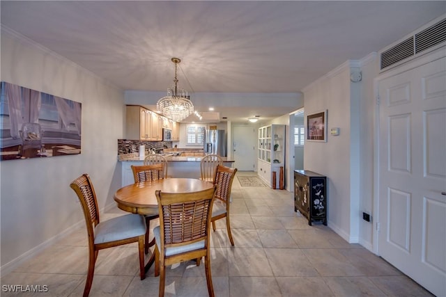 tiled dining room with an inviting chandelier