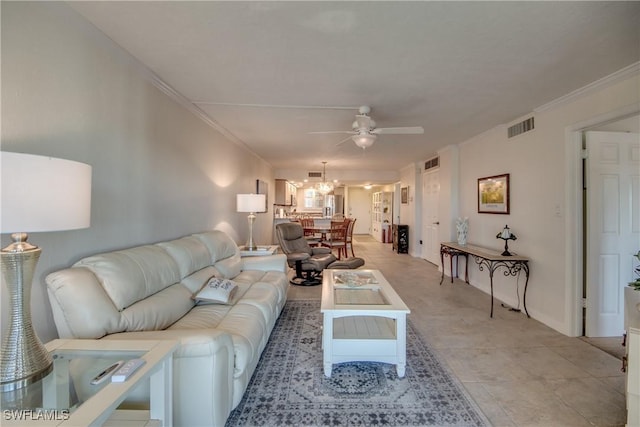 living room with ceiling fan and crown molding