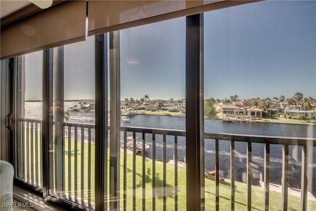 sunroom / solarium featuring a water view