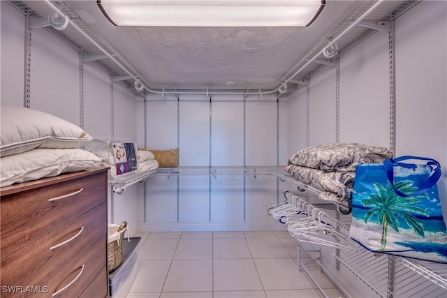 spacious closet featuring light tile patterned flooring