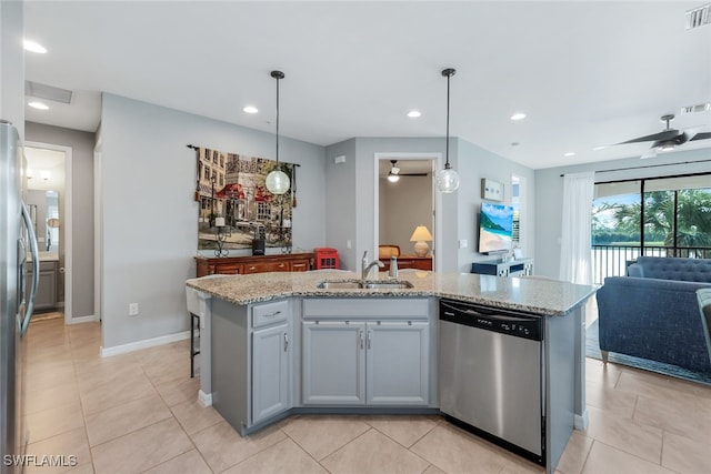 kitchen with a center island with sink, appliances with stainless steel finishes, pendant lighting, and sink