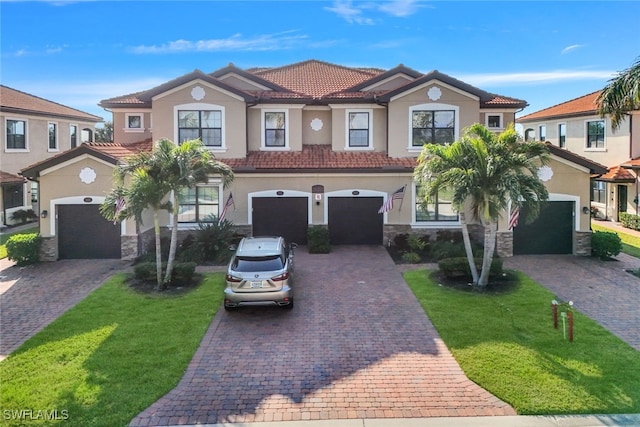 mediterranean / spanish house with a front lawn and a garage