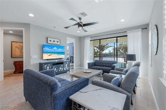 living room with ceiling fan and light tile patterned flooring