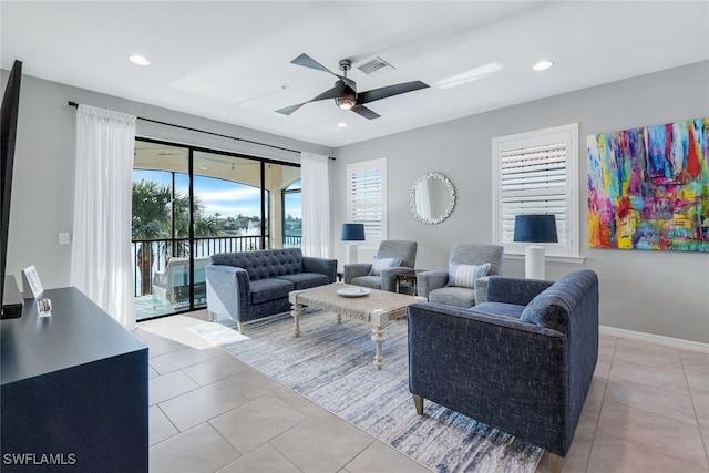 living room with ceiling fan and light tile patterned flooring