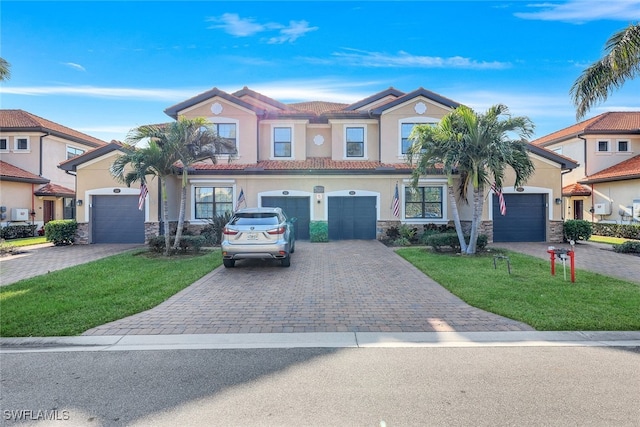 view of front of home featuring a garage and a front lawn