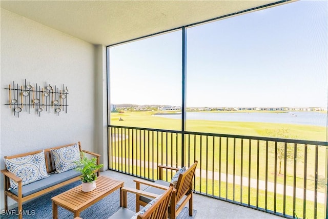 sunroom / solarium featuring a water view