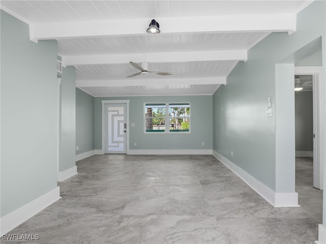 unfurnished room featuring vaulted ceiling with beams, a ceiling fan, and baseboards