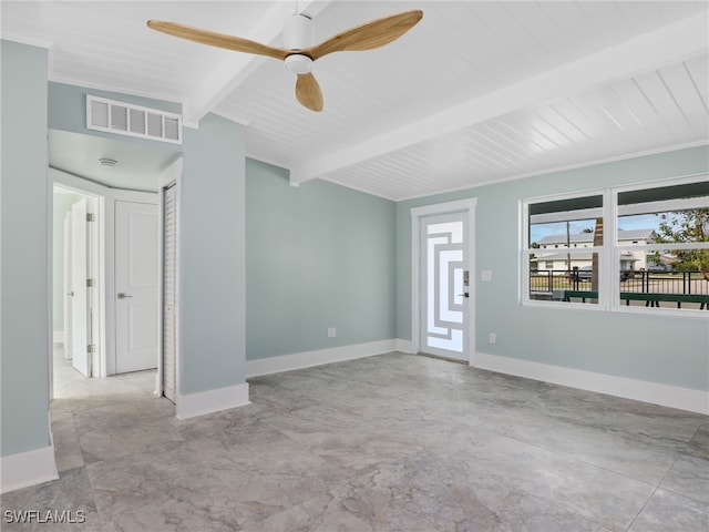 spare room featuring ceiling fan and beamed ceiling