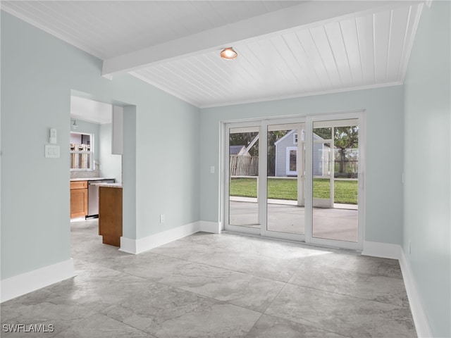 spare room with beamed ceiling and baseboards