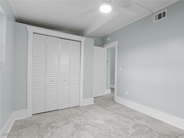 unfurnished bedroom with marble finish floor, a closet, visible vents, and baseboards