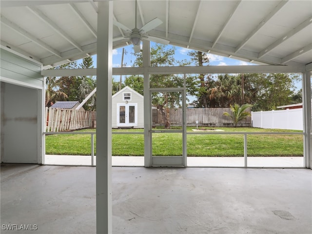 unfurnished sunroom featuring ceiling fan, lofted ceiling, and a healthy amount of sunlight