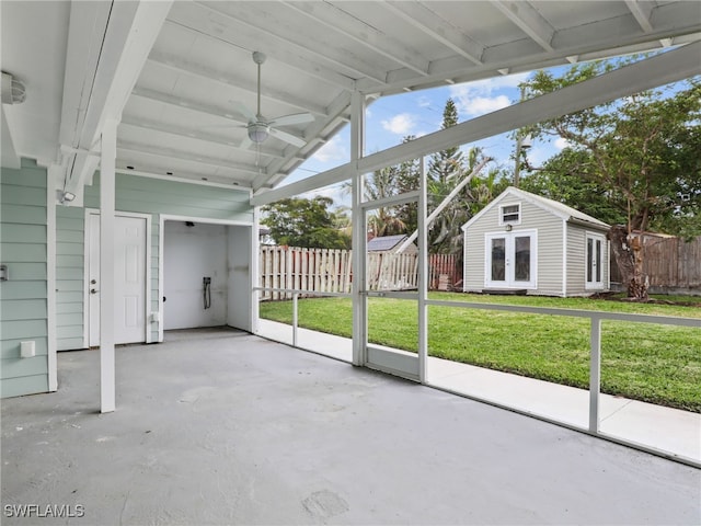 unfurnished sunroom with a ceiling fan and lofted ceiling with beams