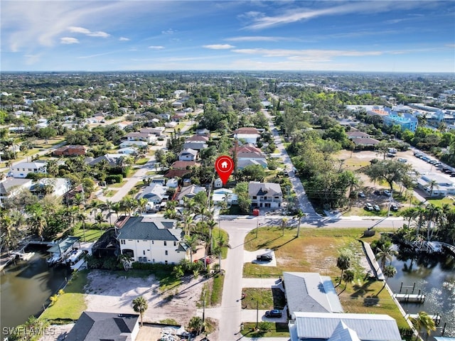 drone / aerial view with a water view and a residential view